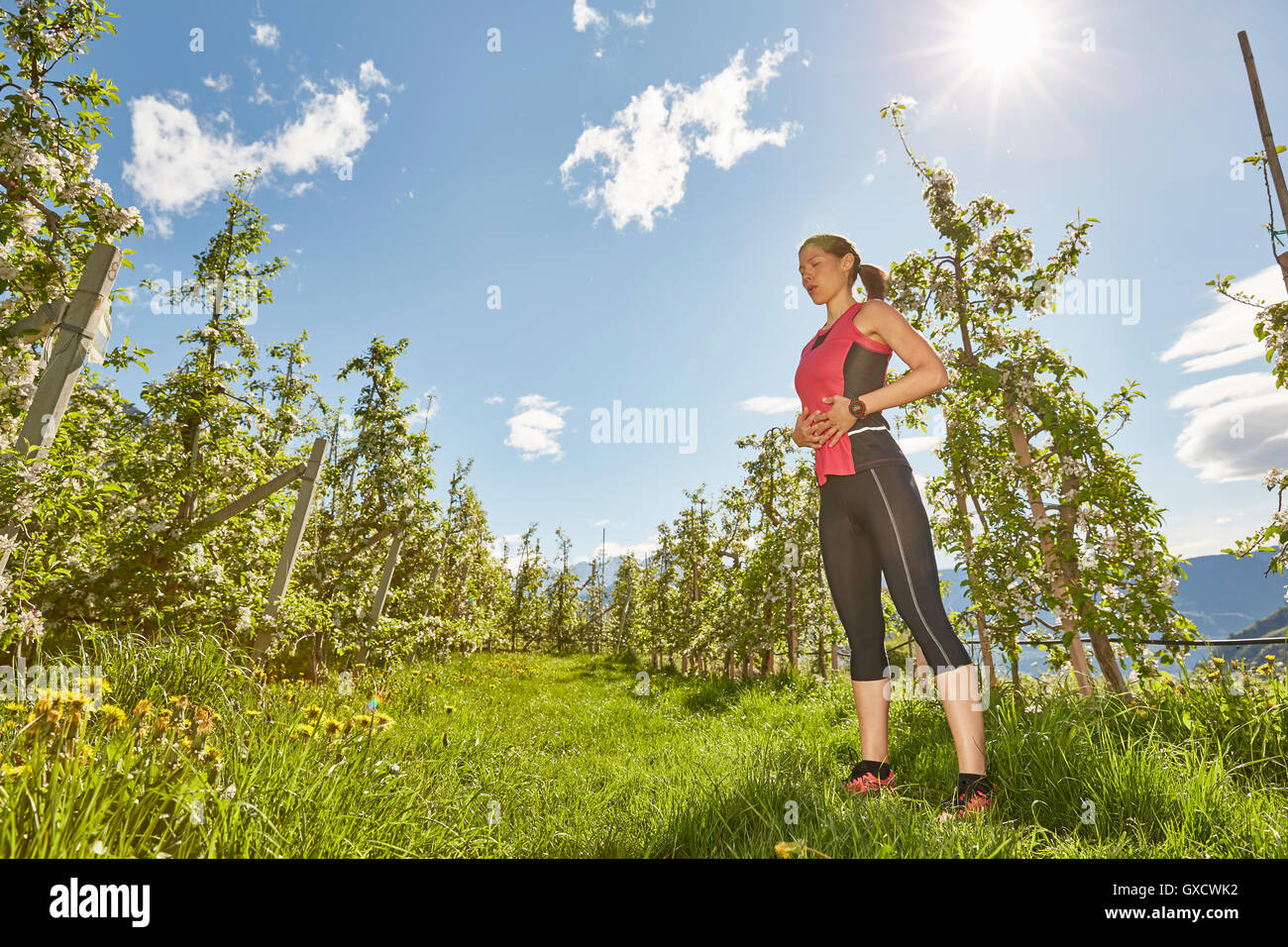 Young woman meditating outdoors, Meran, South Tyrol, Italy Stock Photo