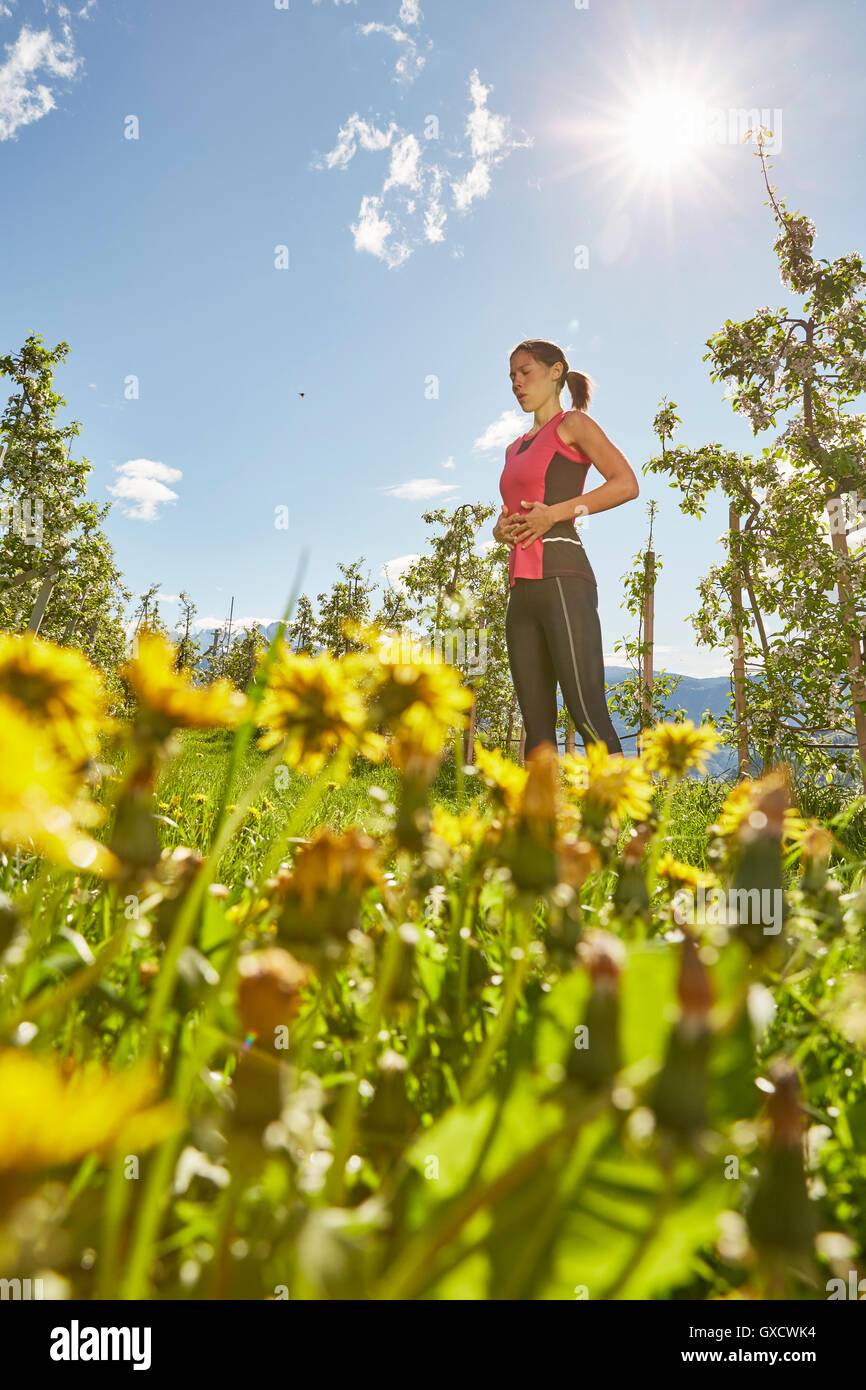 Young woman meditating outdoors, Meran, South Tyrol, Italy Stock Photo