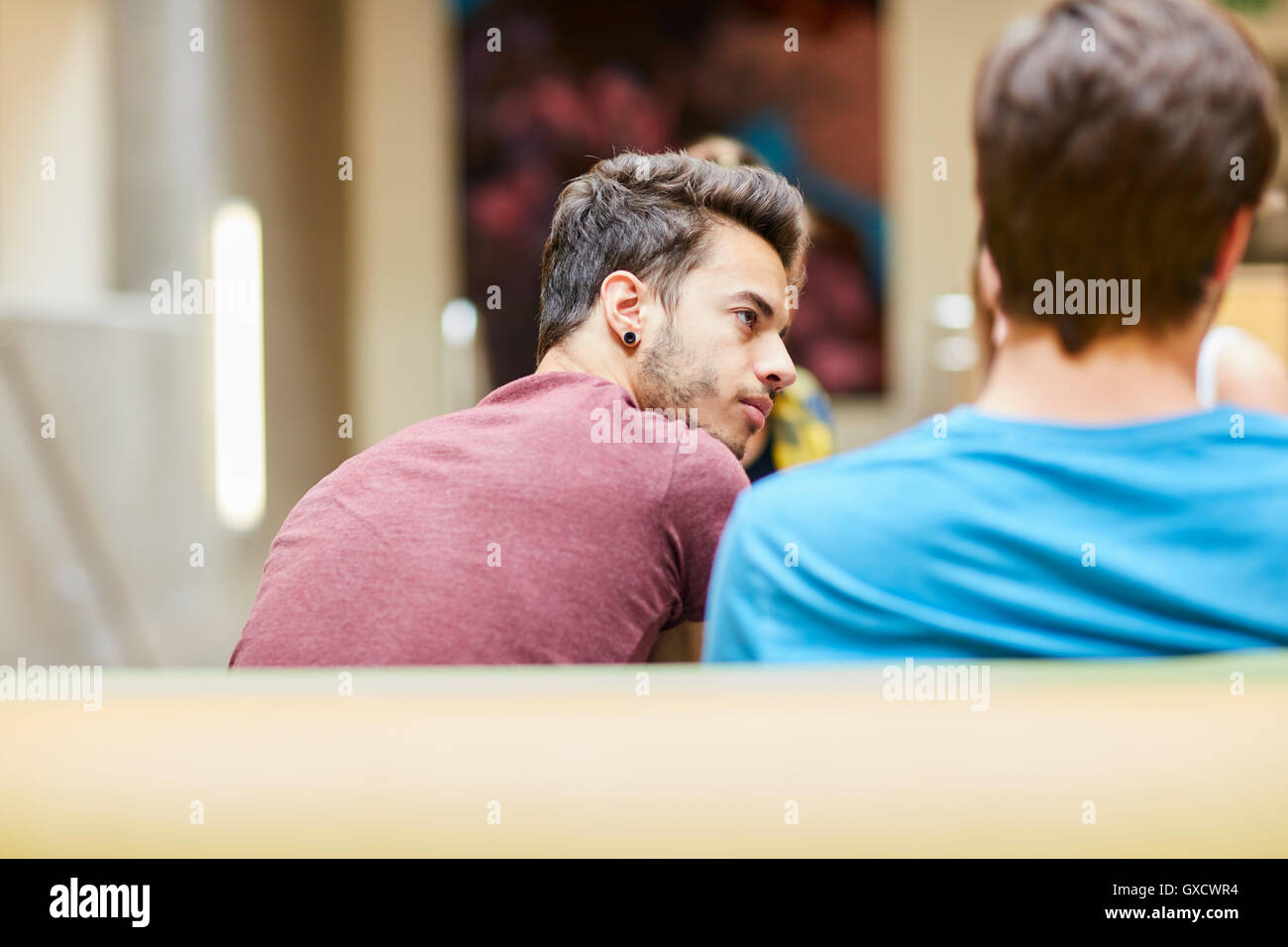 Rear view of male students in canteen at higher education college Stock Photo