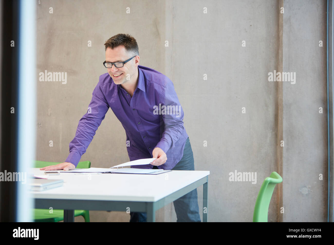 Male designer preparing paperwork in design studio Stock Photo