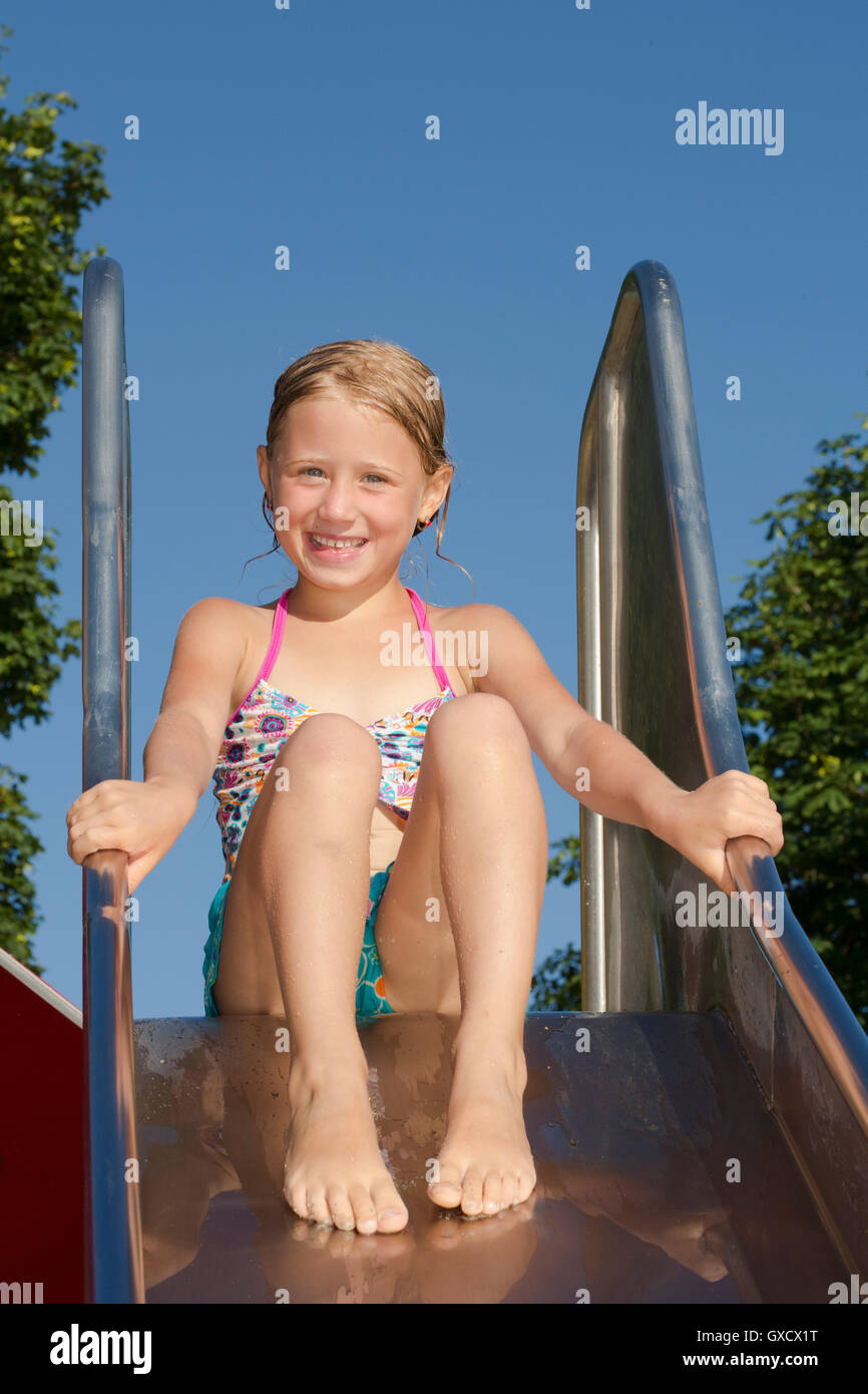 Portait of girl on water slide at Lake Seeoner See, Bavaria, Germany Stock Photo