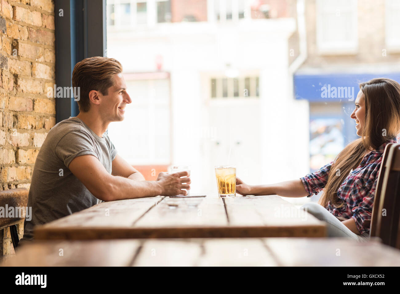 Young couple chatting in bar Stock Photo