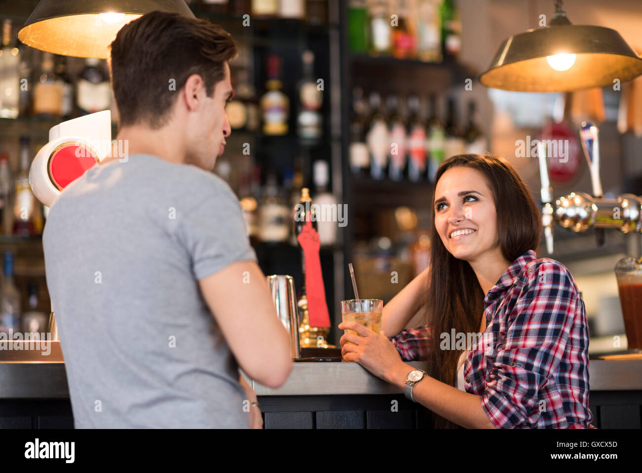 Young couple talking at bar Stock Photo