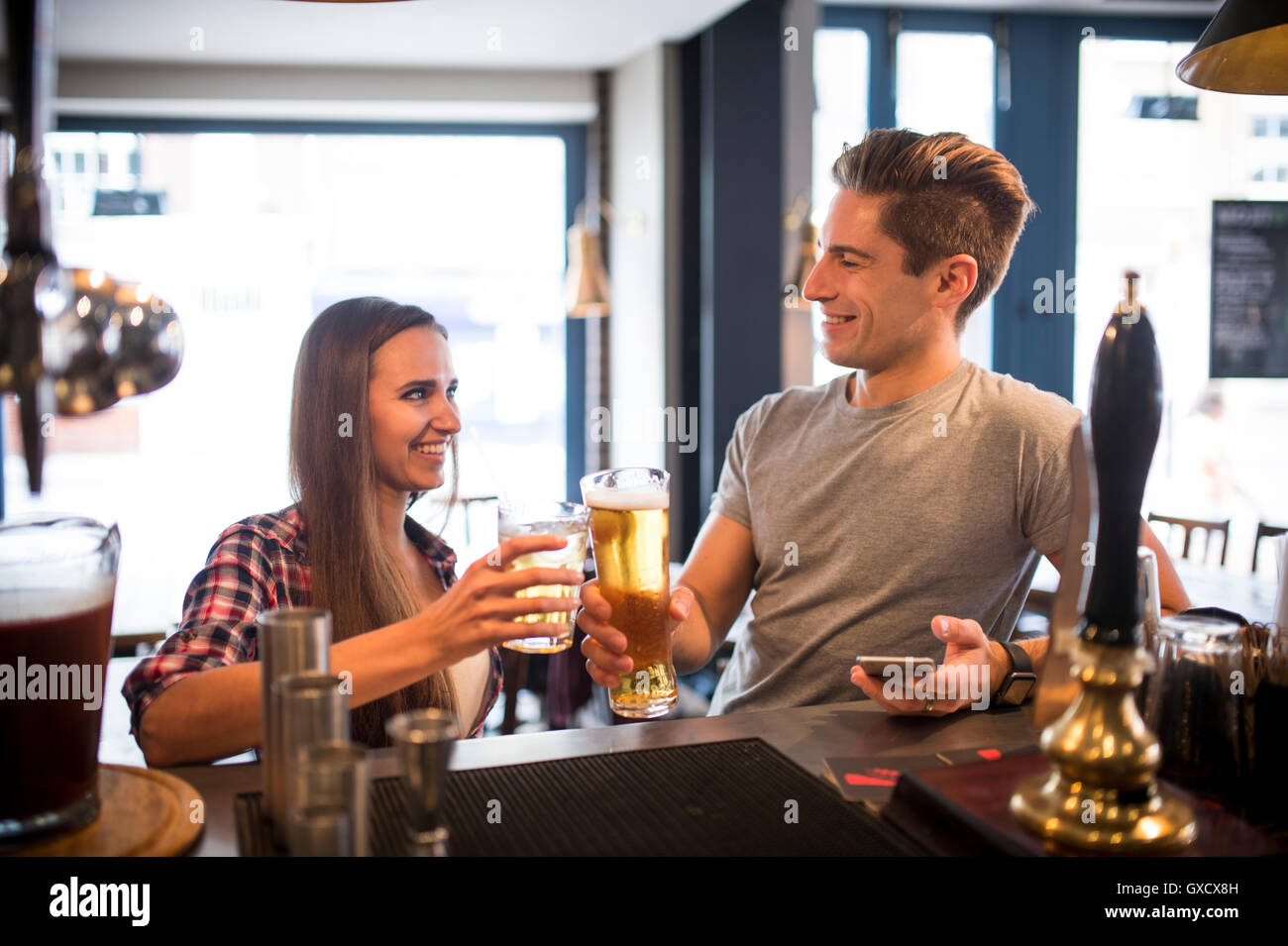 Young couple raising a toast at city bar Stock Photo Alamy