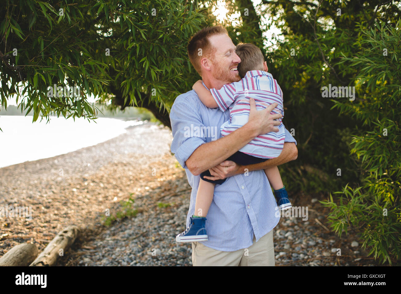 Father and young son hugging at Lake Ontario, Oshawa, Canada Stock Photo