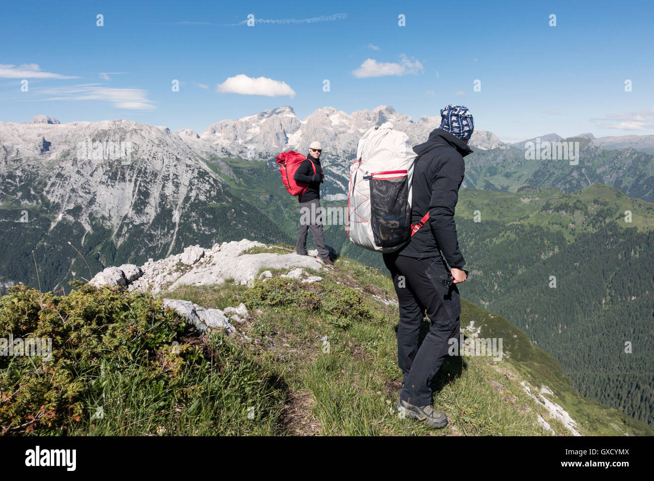 Two wingsuit BASE jumpers walking to the exit spot at Col di Pra, Italian Alps, Alleghe, Belluno, Italy Stock Photo