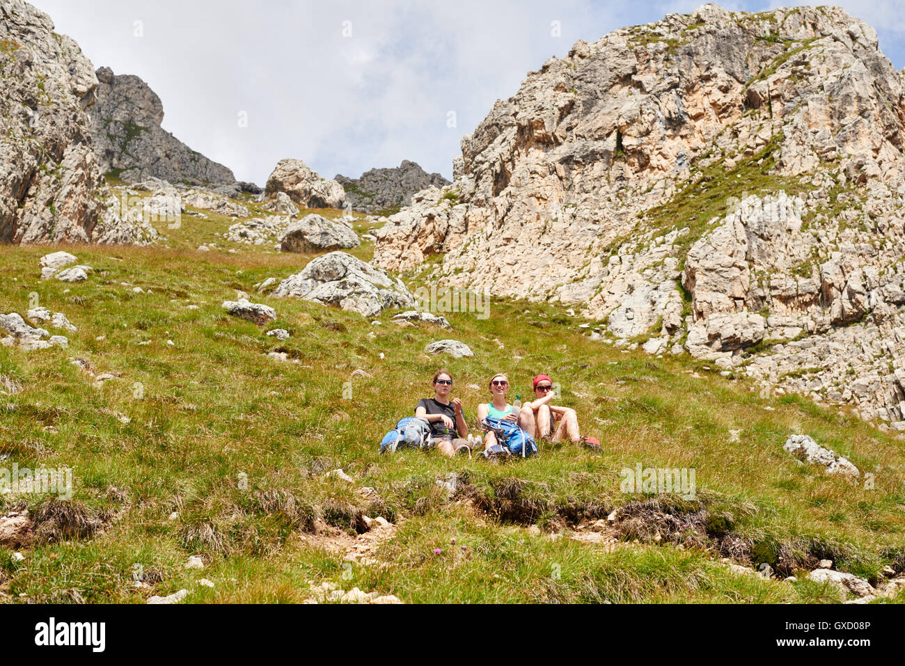 Hikers resting on rocky hillside, Austria Stock Photo