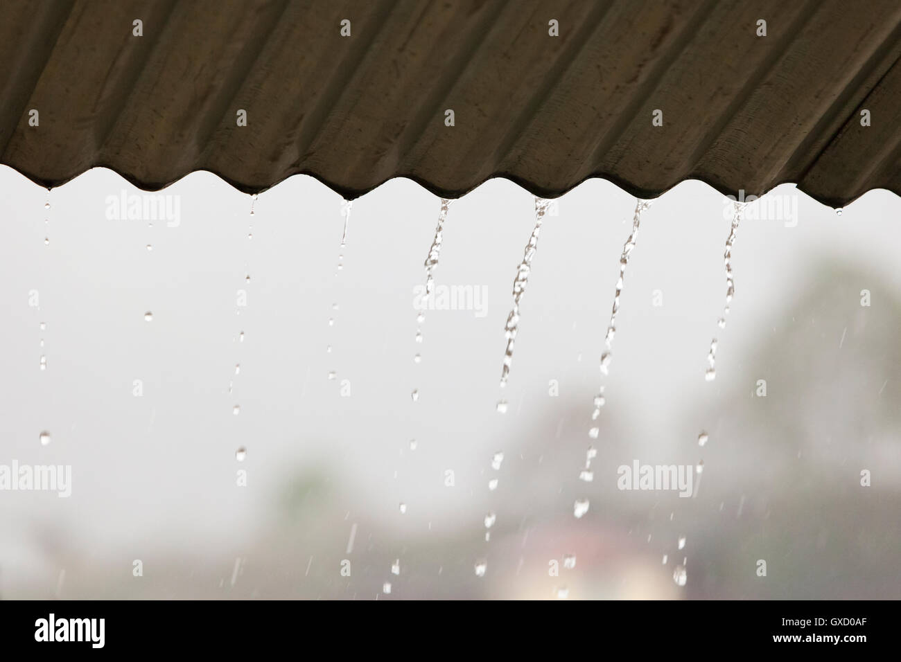 Rain dripping from roof edge, Nepal Stock Photo