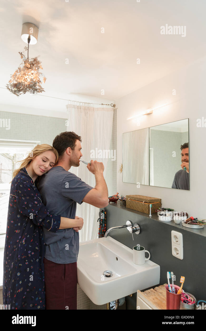 Couple in bathroom brushing teeth Stock Photo