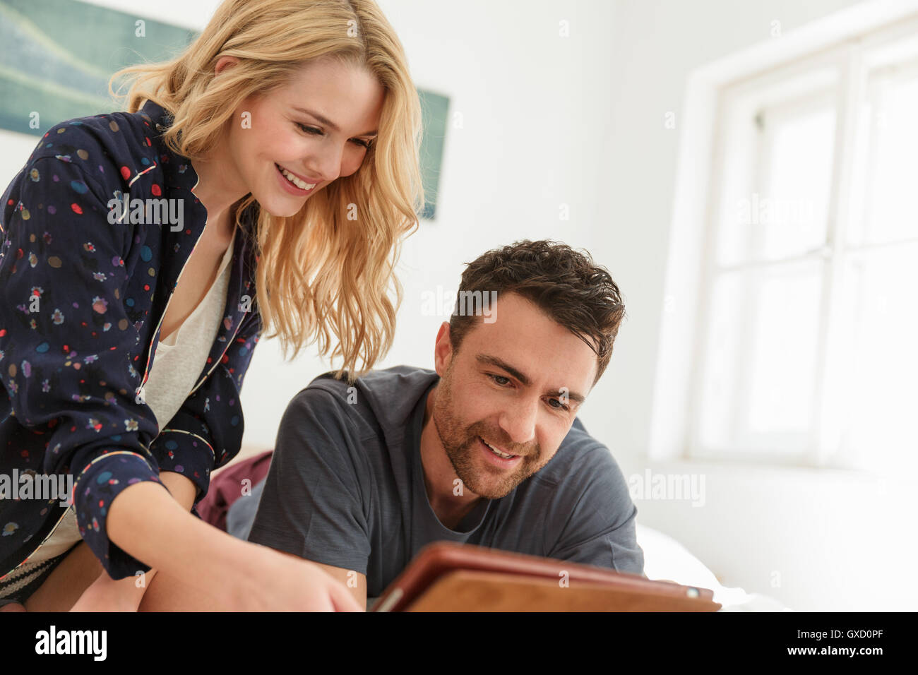 Couple using digital tablet smiling Stock Photo
