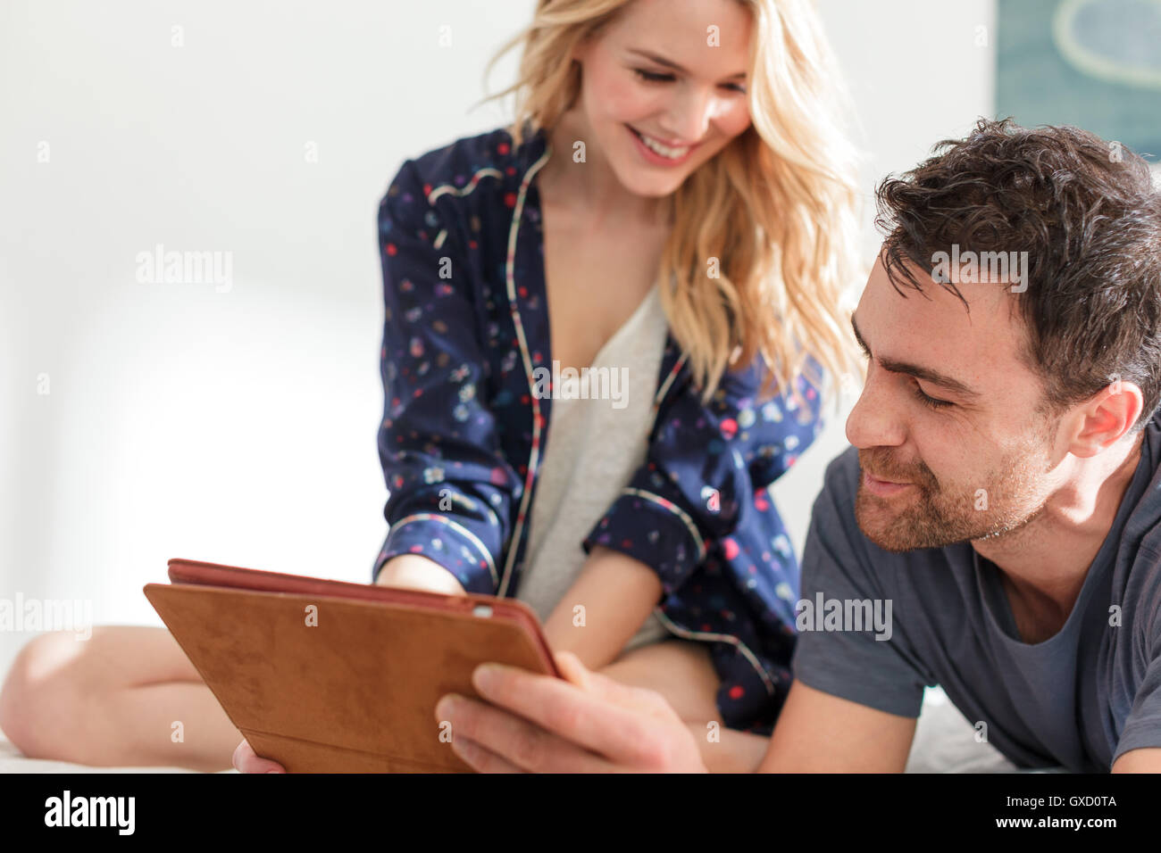 Couple looking at digital tablet smiling Stock Photo