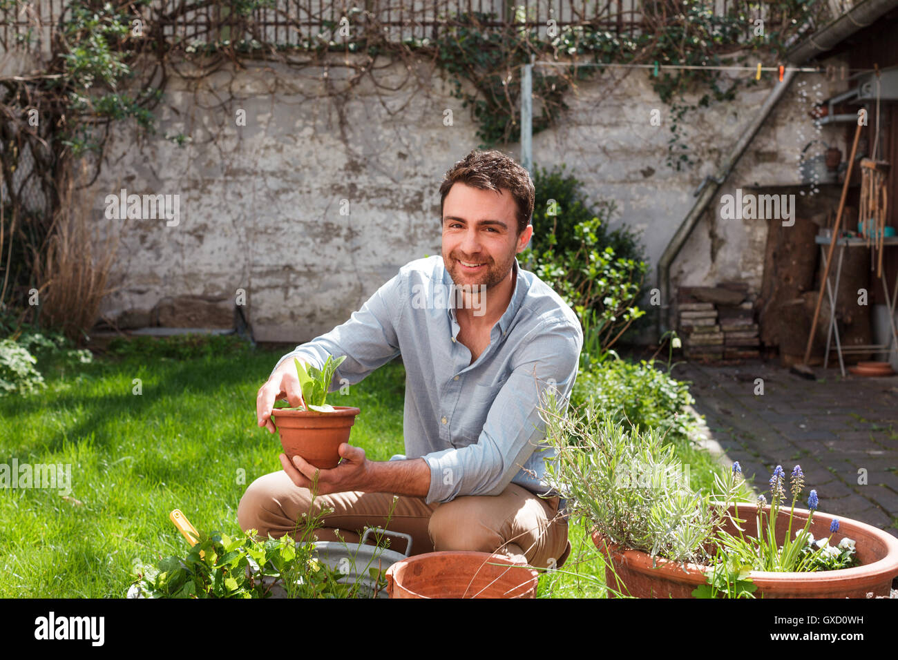 Man in garden tending to plants Stock Photo