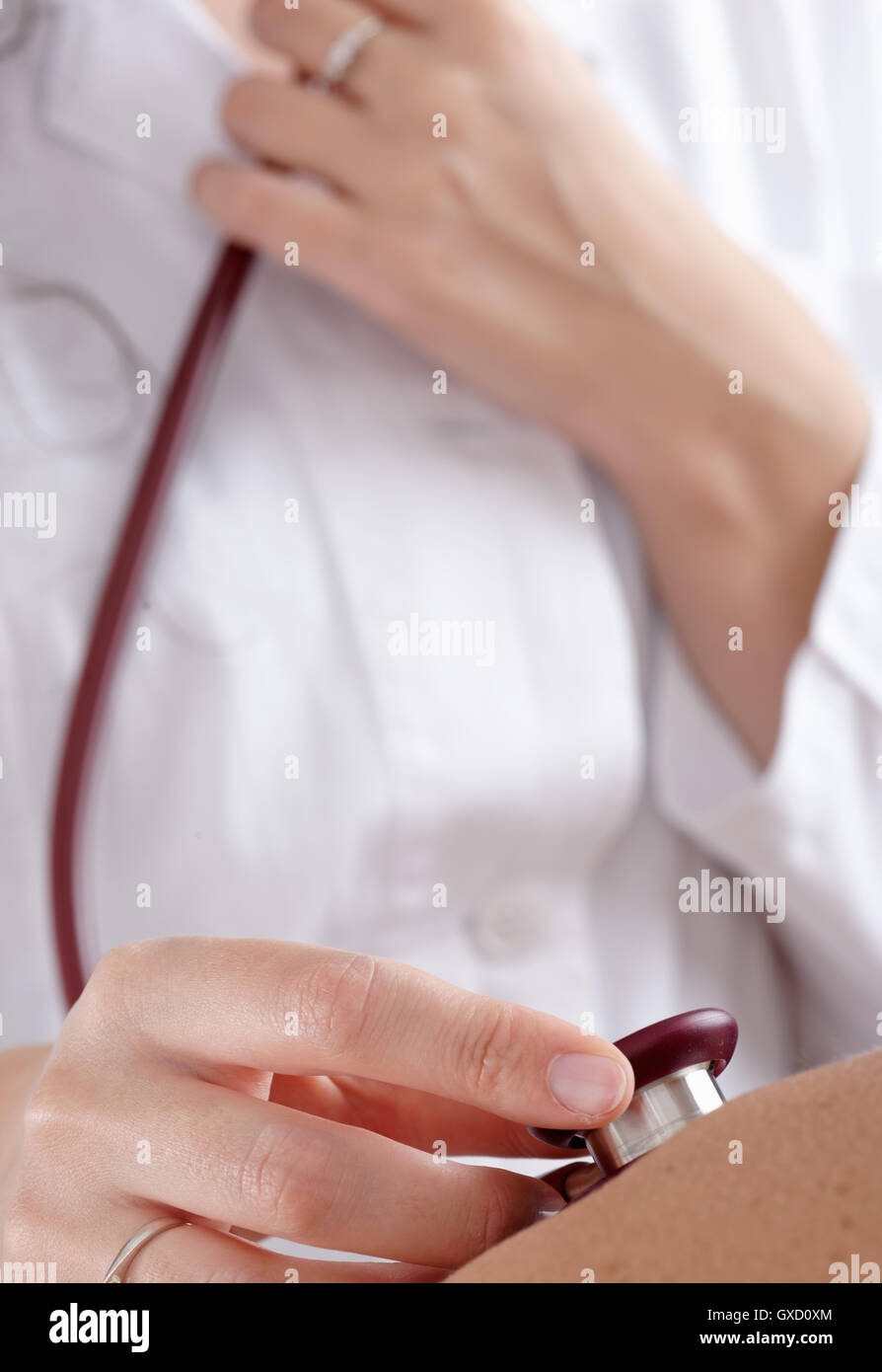 Doctor examining patients with stethoscope Stock Photo