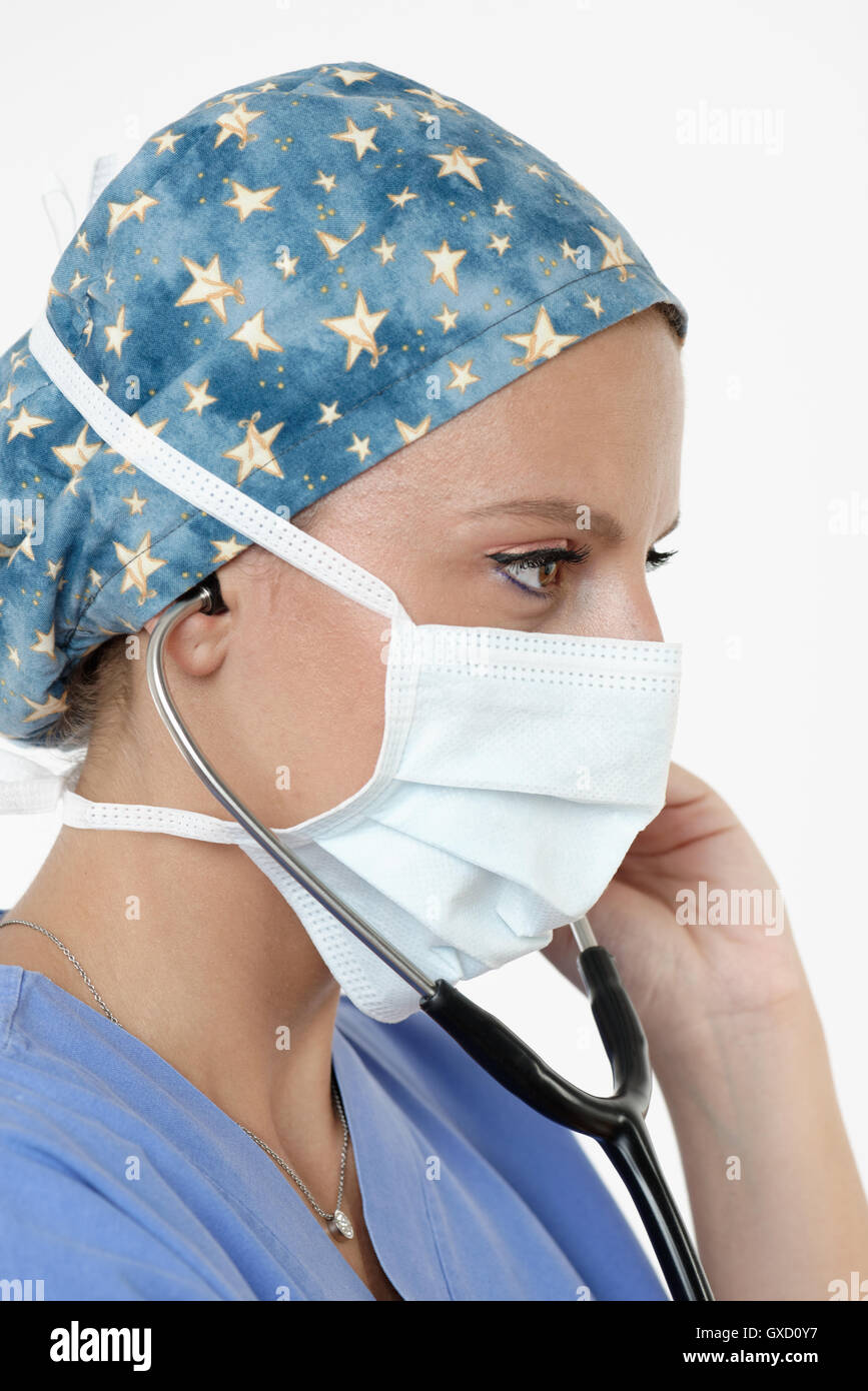 Surgeon wearing surgical cap, mask and stethoscope looking away Stock Photo