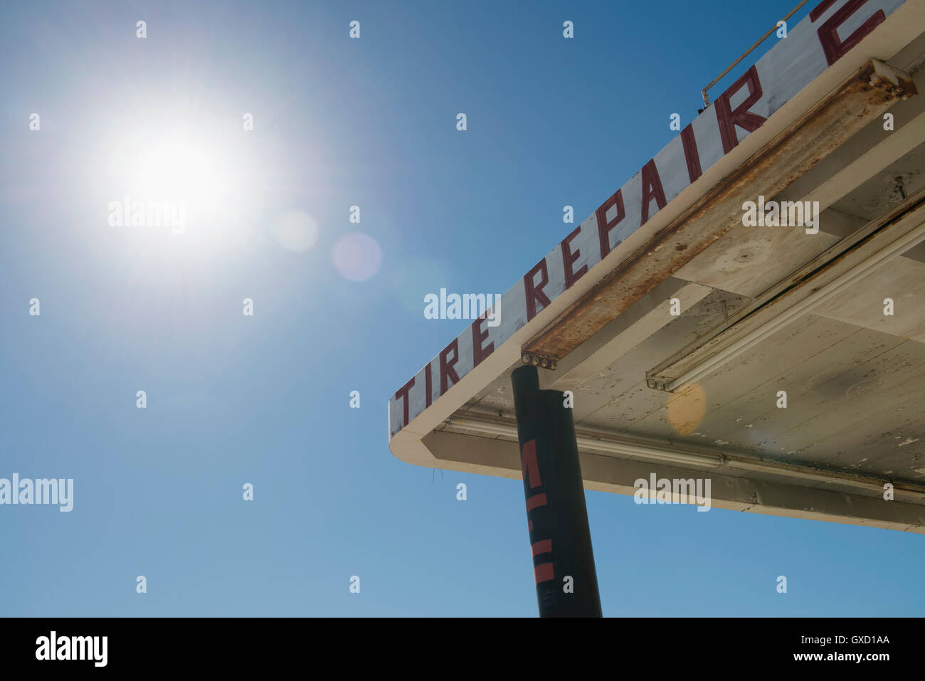 Abandoned repair garage against sunlit blue sky, Salton Sea, California