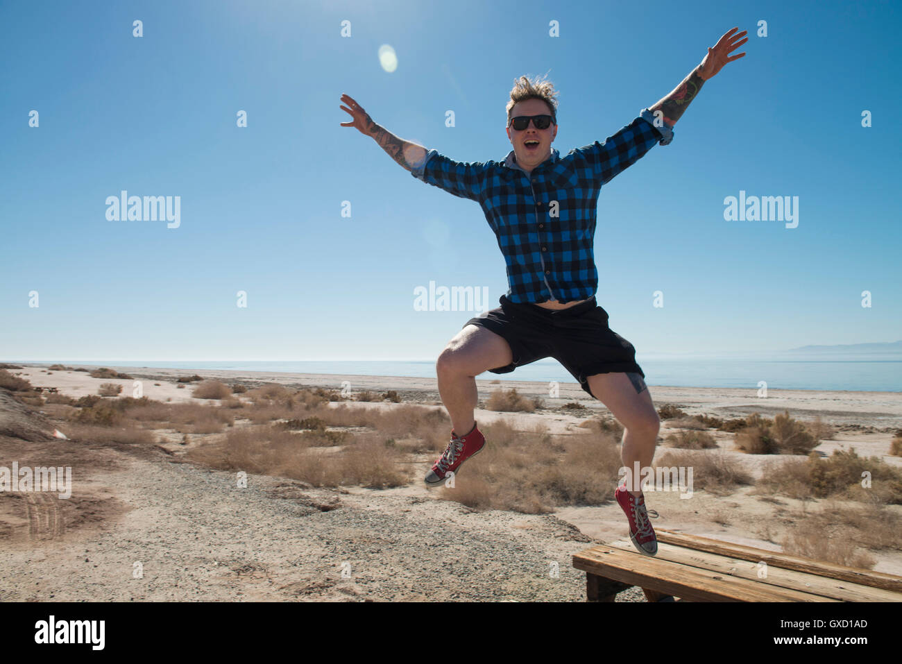 Man jumping mid air, Salton Sea, California , USA Stock Photo