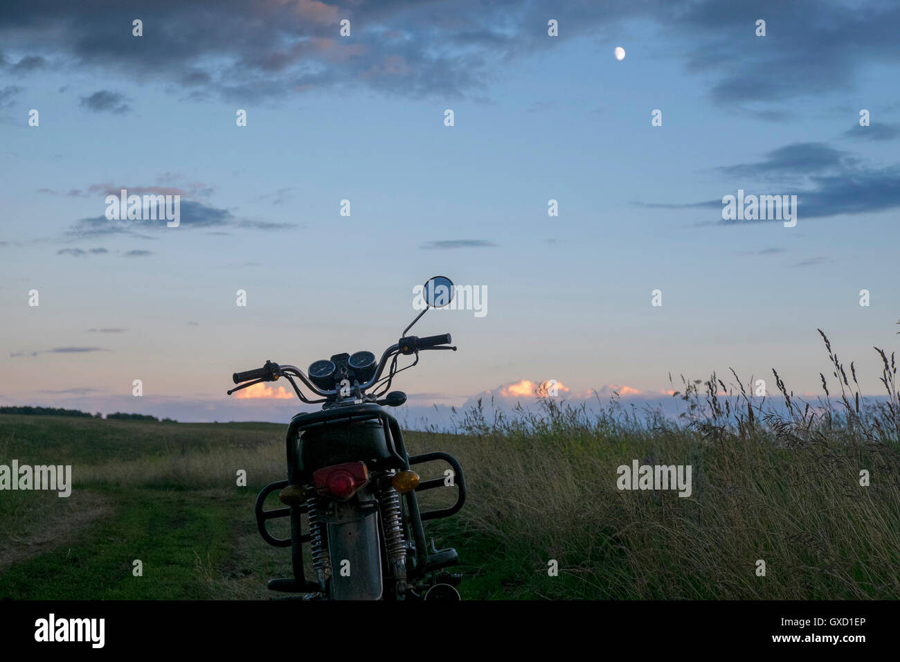 Motorbike parked in rural landscape, Ural, Russia Stock Photo
