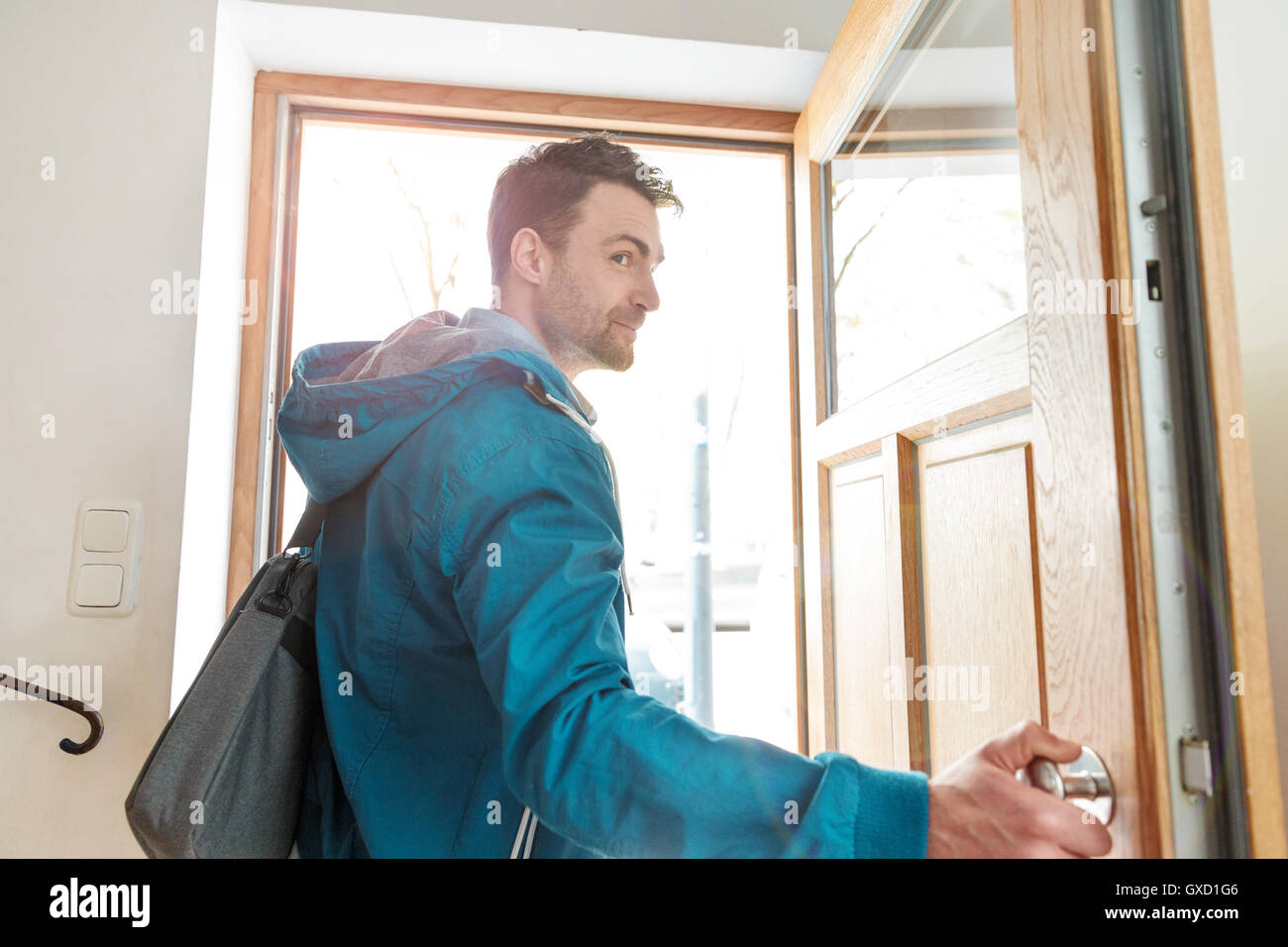 Man leaving front door of house Stock Photo - Alamy