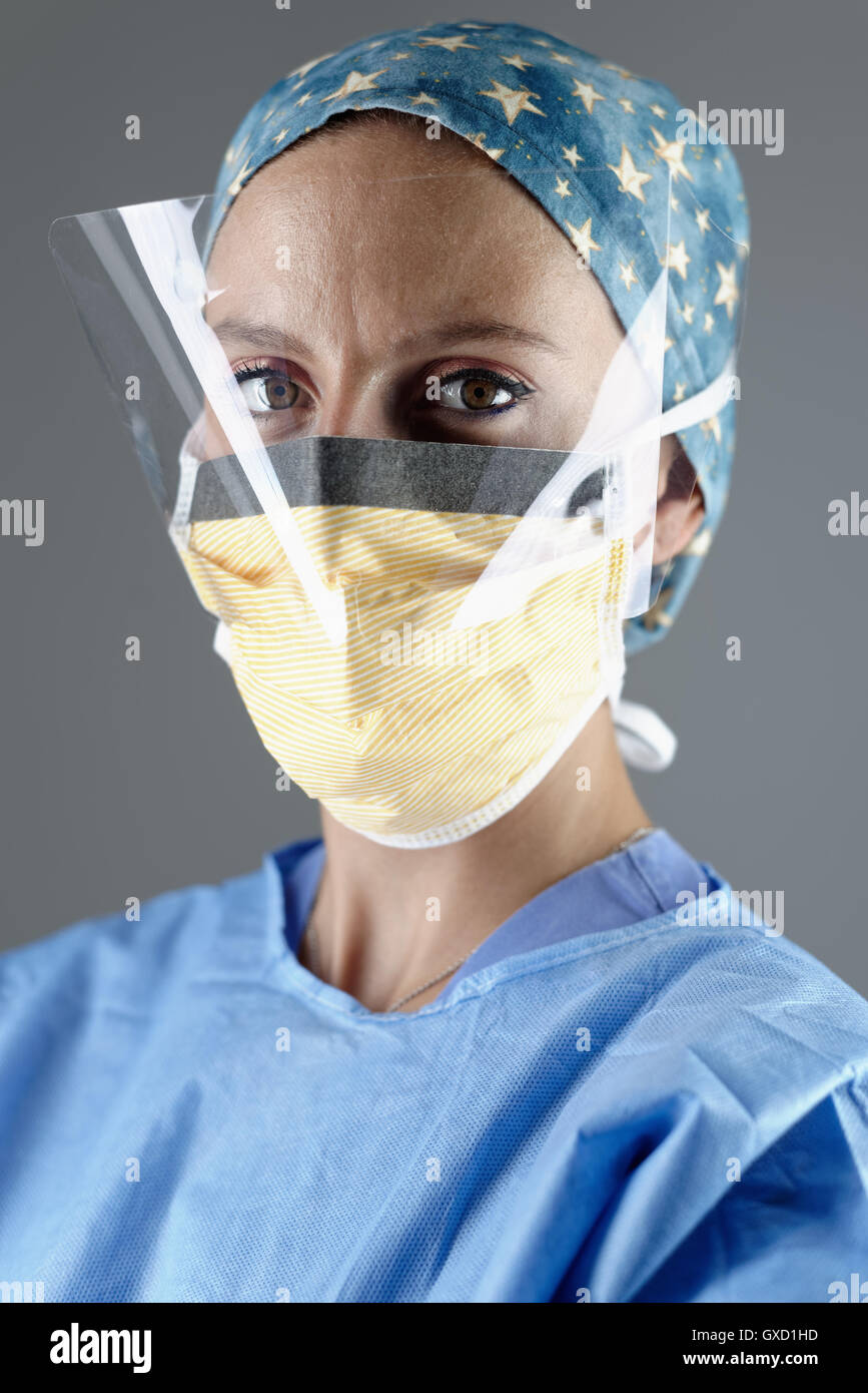 Surgeon wearing surgical eye guard and face mask looking at camera Stock Photo