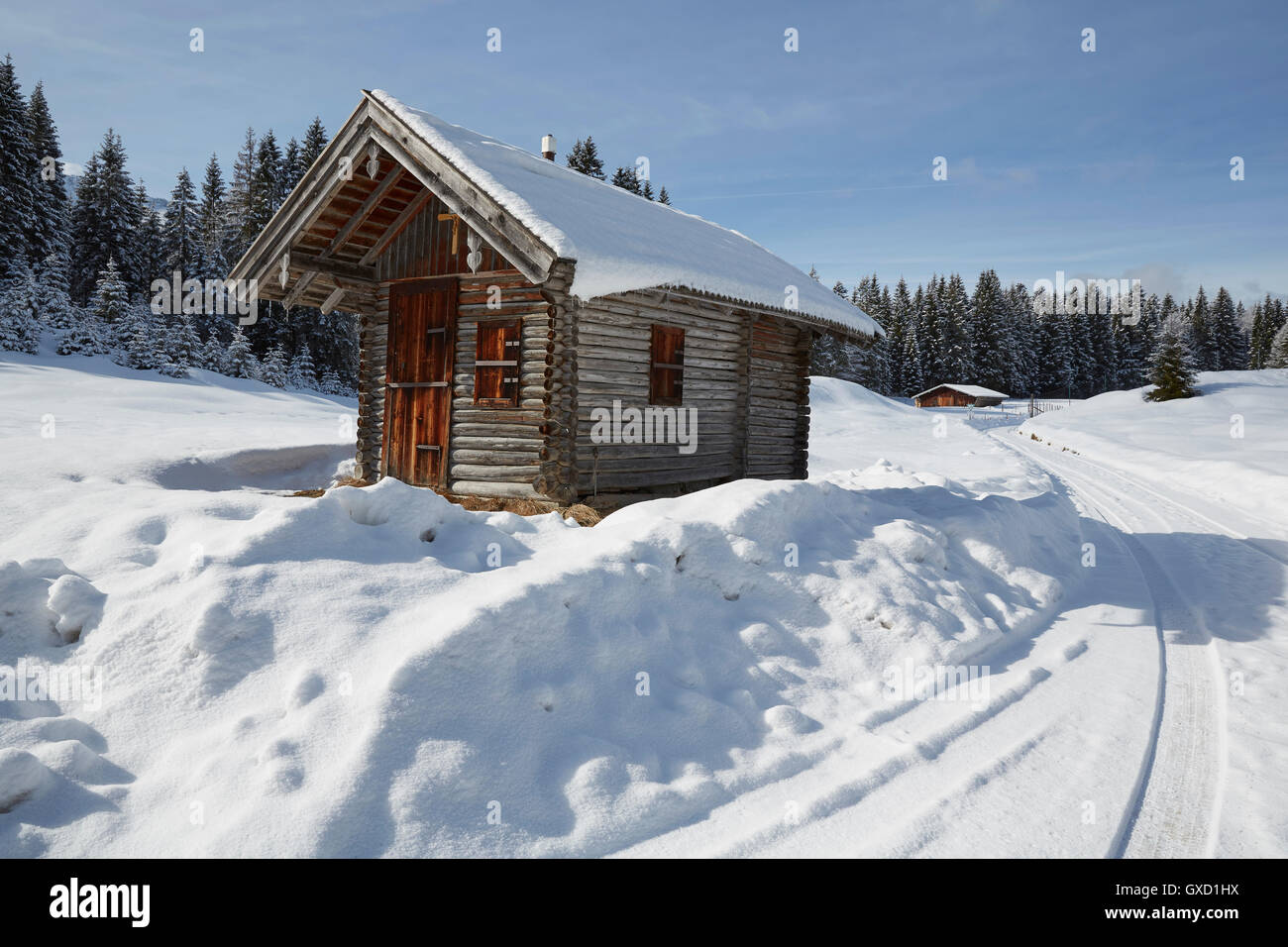 Log cabin on snow covered landscape, Elmau, Bavaria, Germany Stock Photo