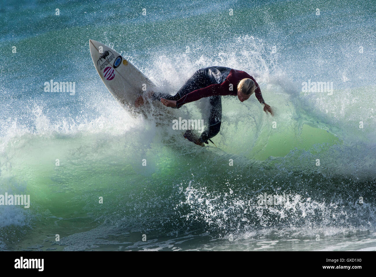 A surfer in spectacular action at Fistral in Newquay, Cornwall. UK. Stock Photo