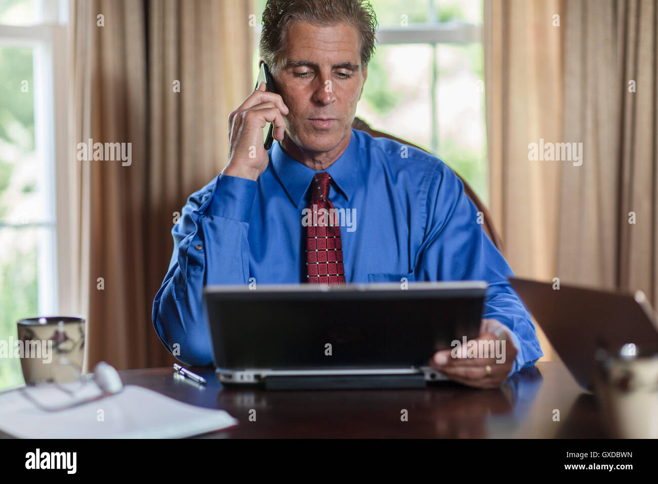 Mature man at home using laptop hi-res stock photography and images - Alamy