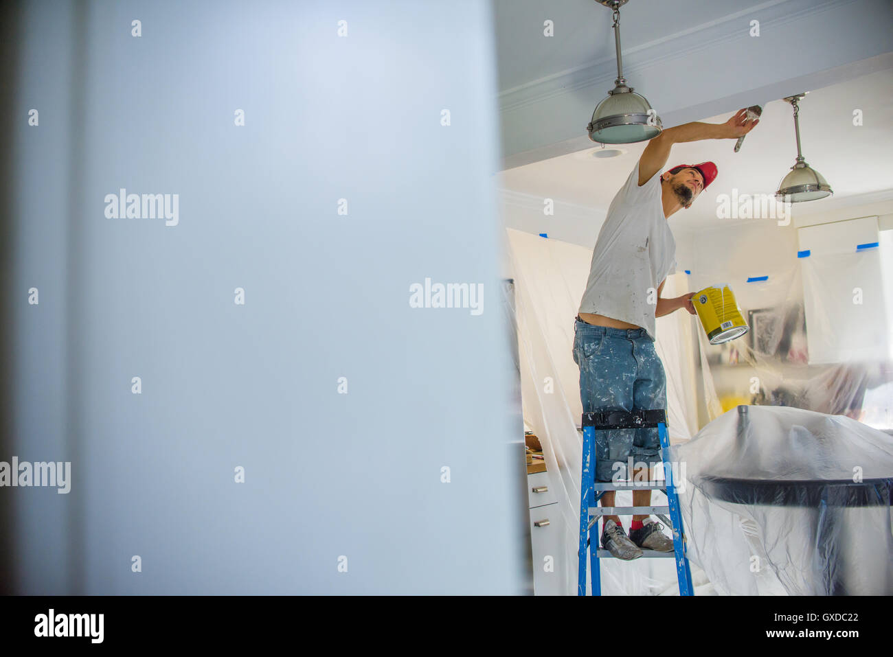 Man up ladder painting hi-res stock photography and images - Alamy