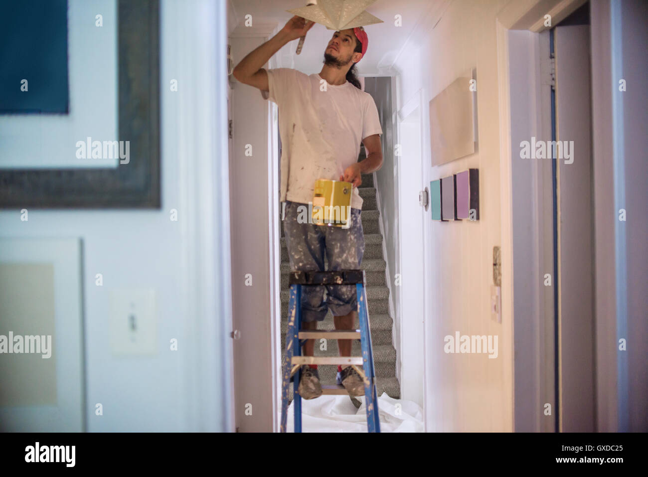 Man up ladder painting hi-res stock photography and images - Alamy