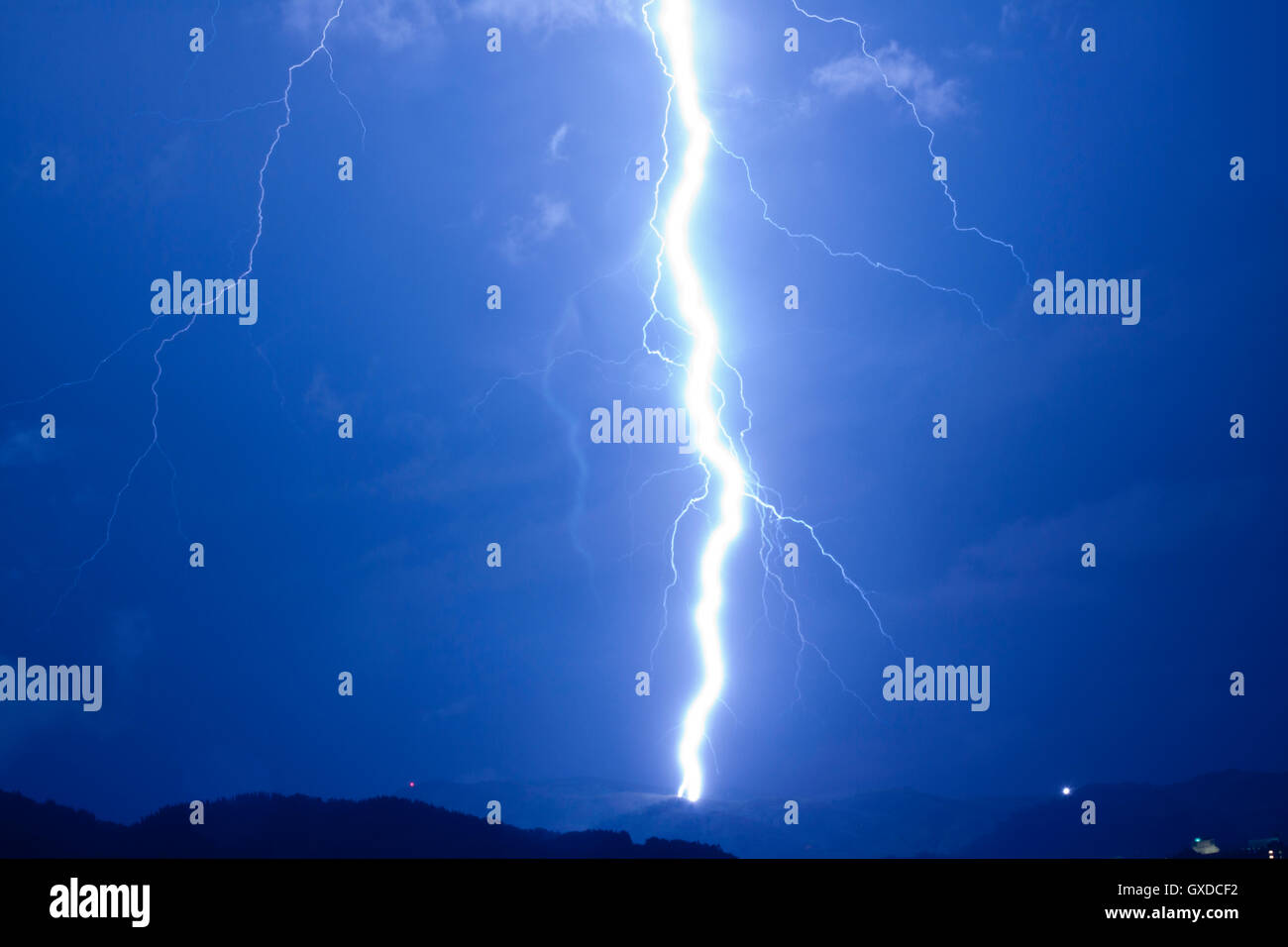 Lightning Strikes hit over night landscape Stock Photo