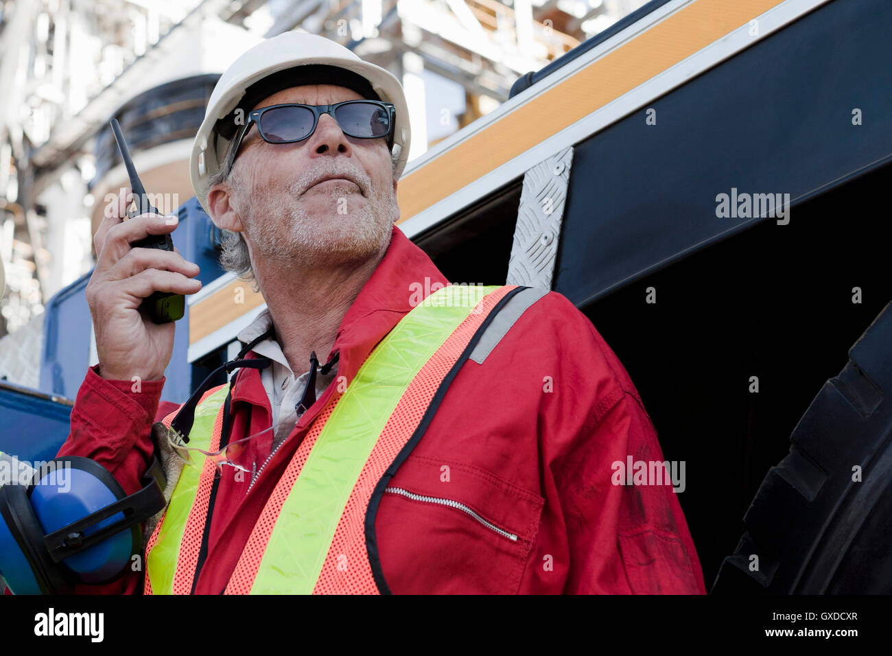 Engineer using walkie talkie on oil rig Stock Photo Alamy