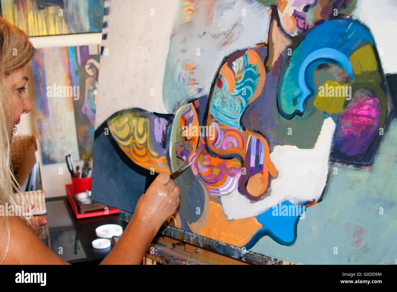 Artist painting artwork on canvas Stock Photo