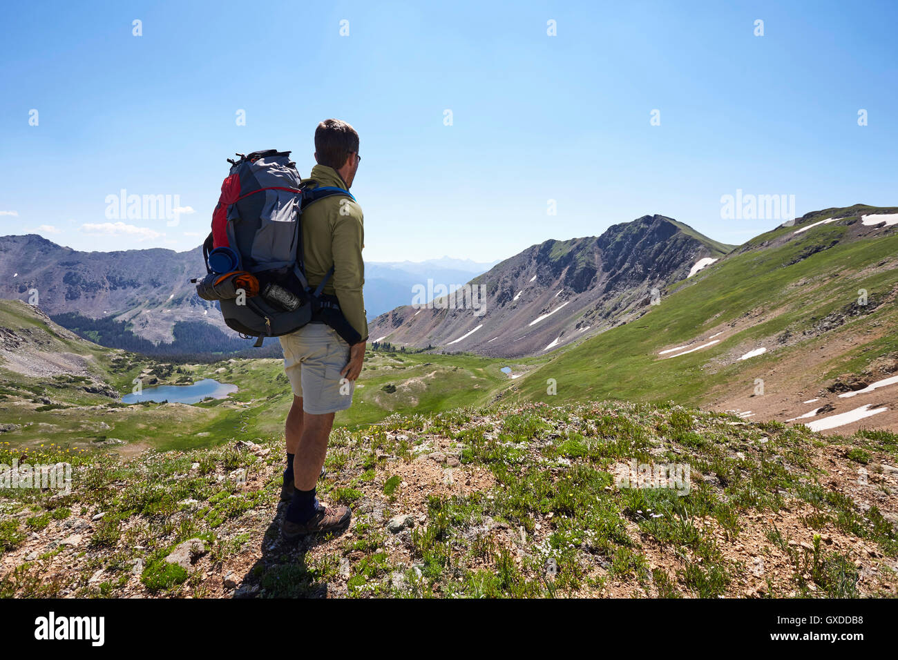 Male backpacker looking out at landscape, Never Summer Wilderness, Colorado, USA Stock Photo
