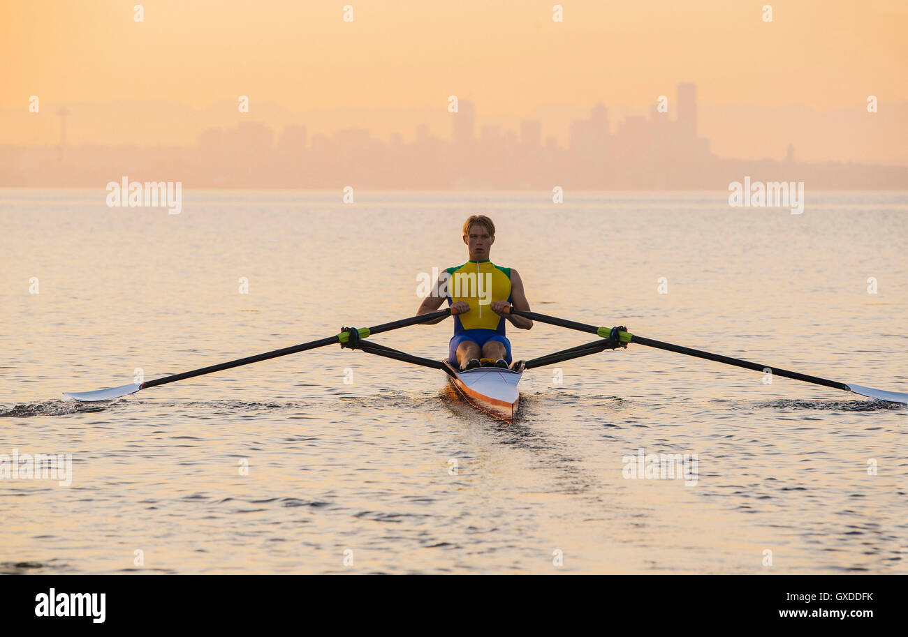 Man rowing row boat in sea around Bainbridge Island, Washington, USA Stock Photo