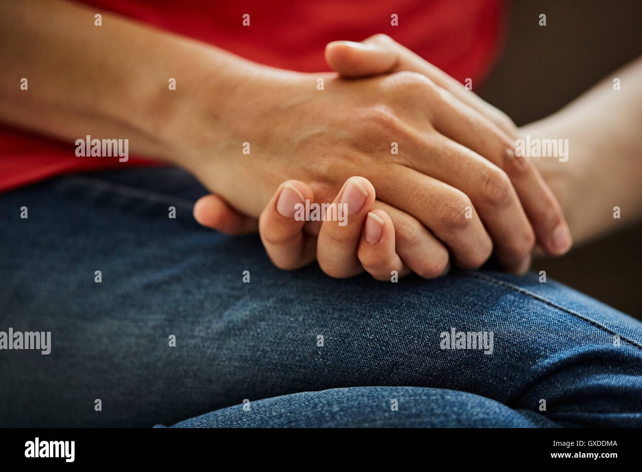 Cropped view of mother and son holding hands Stock Photo