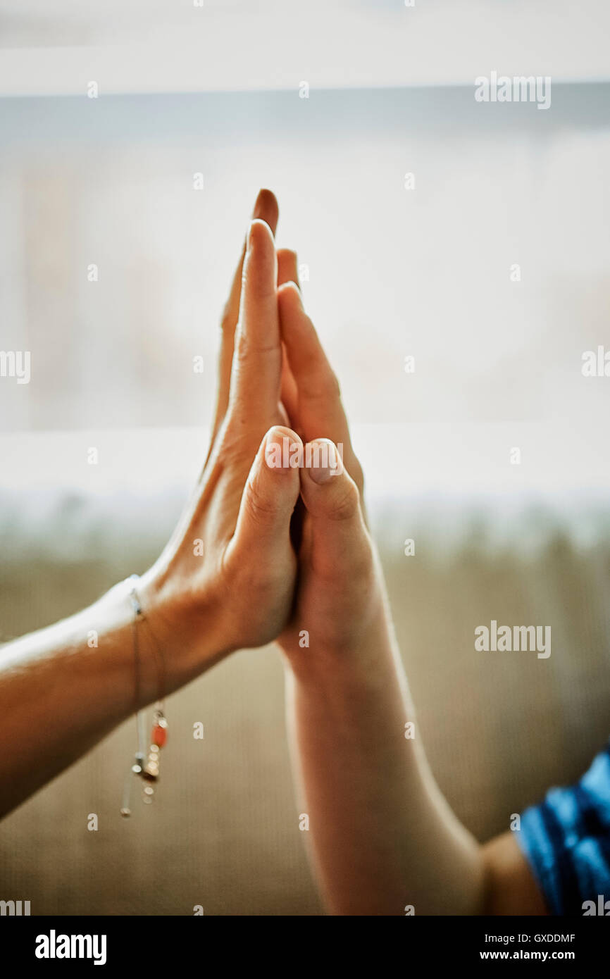 Cropped view of mother and son with hands together Stock Photo