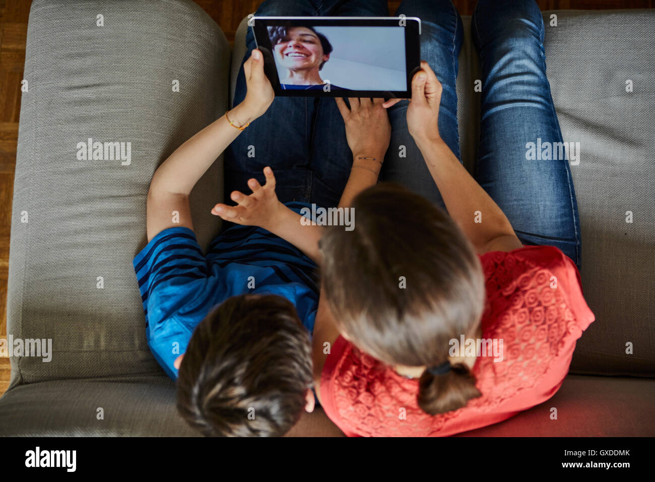 Overhead view of mother and son on sofa using digital tablet Stock Photo
