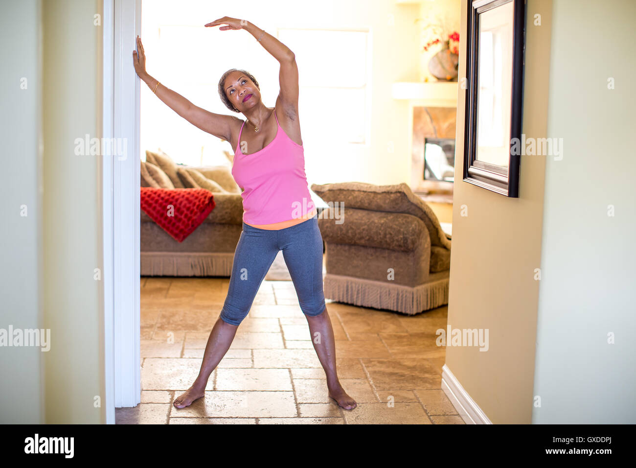 Woman with arms raised doing stretching exercise Stock Photo