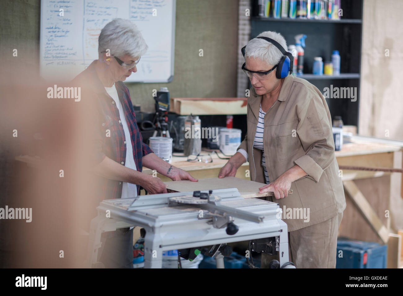 Female carpenters preparing wood in furniture making workshop Stock Photo