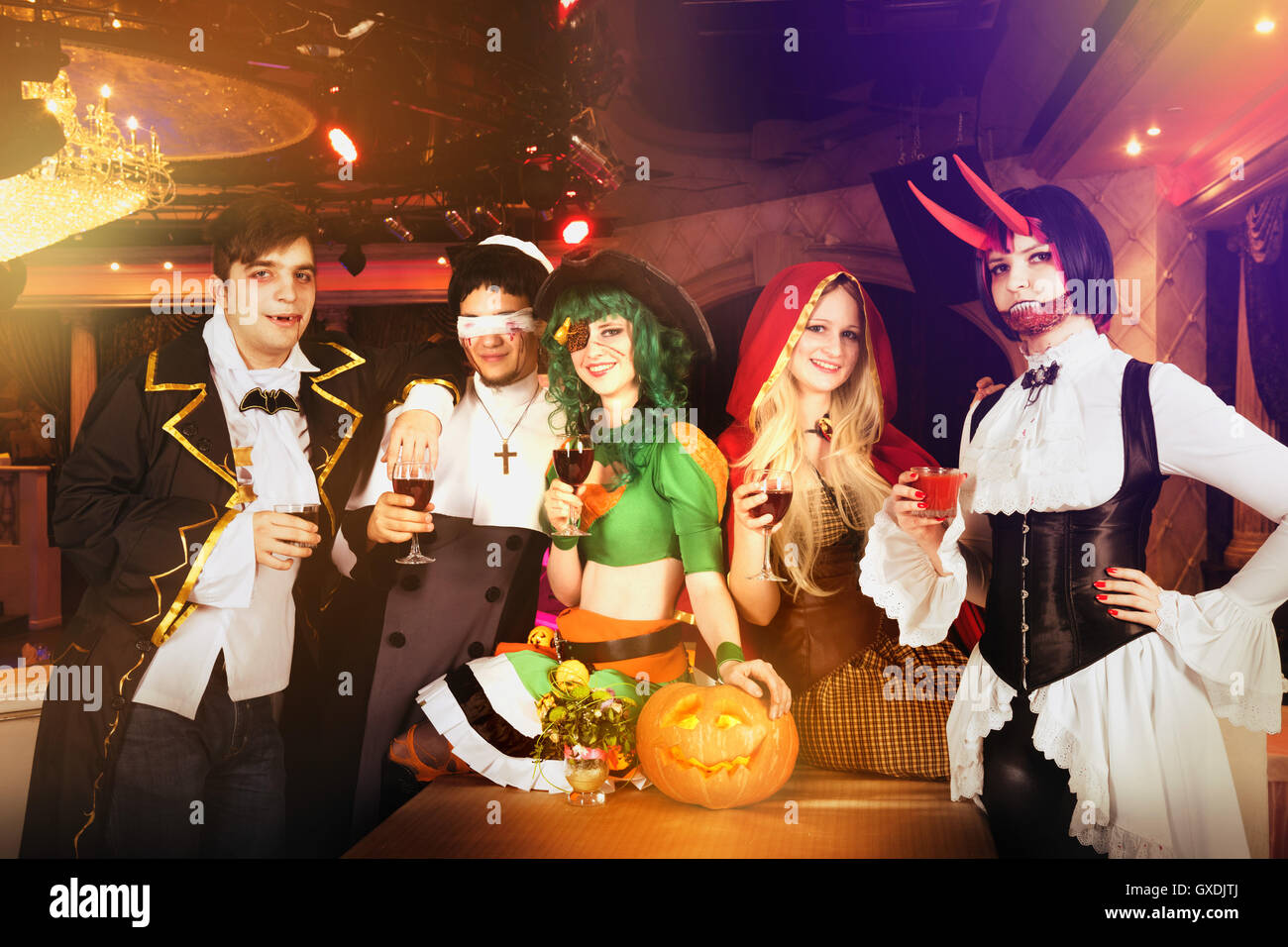 Group of friends at halloween party in costumes Stock Photo