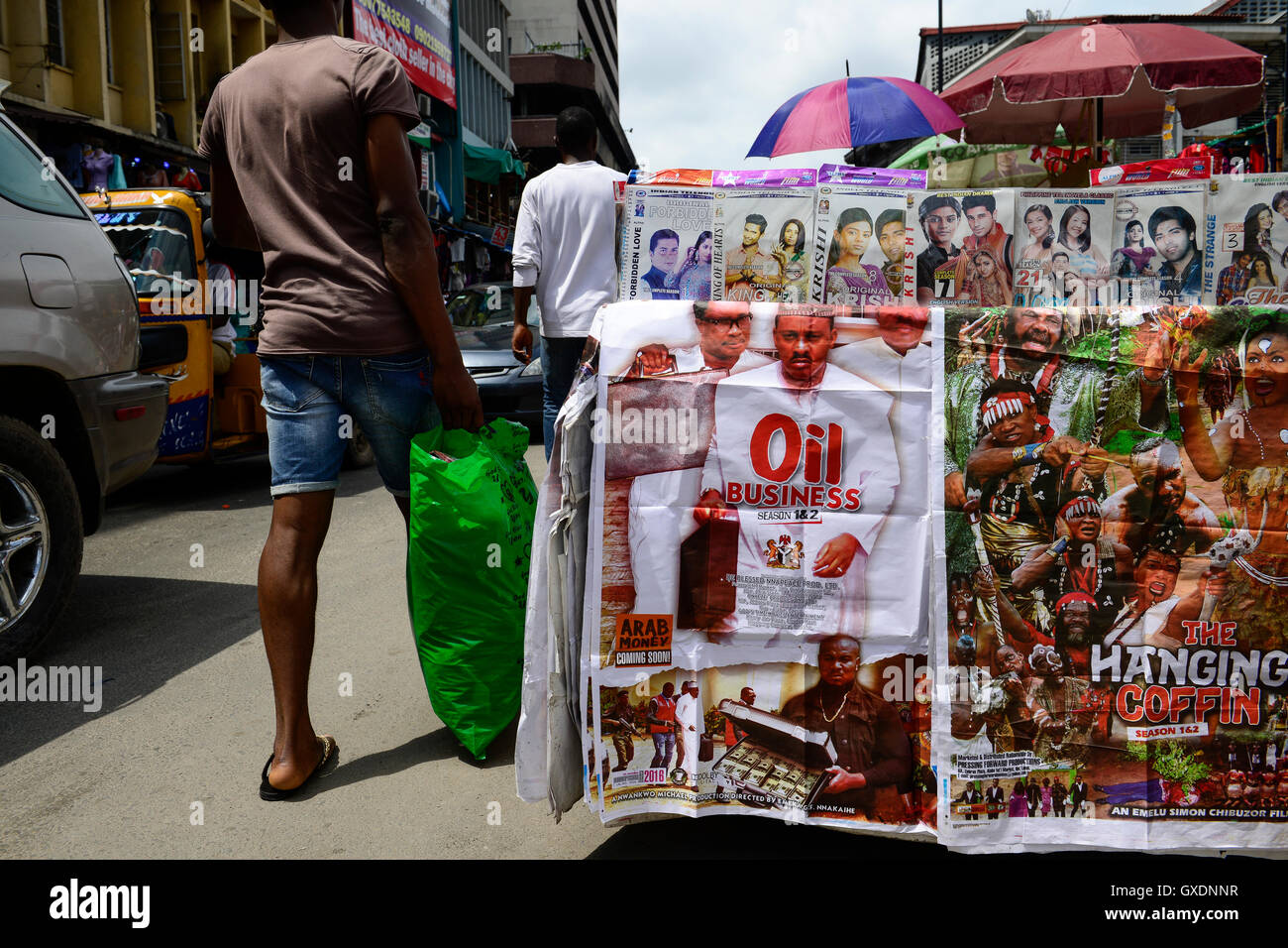 NIGERIA, City Lagos, roadside selling of motion picture by the Nigerian film industry called Nollywood on DVD, nigerian movie thriller Oil business and indian Bollywood movies Stock Photo