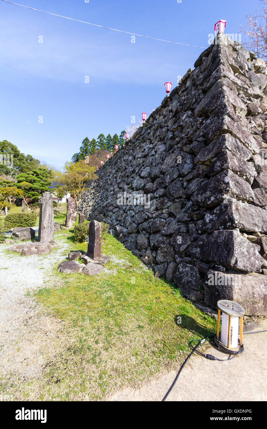 Japan, Izushi castle. Ishigaki, stone wall, with sangizumi style sloped corner. Sunshine, blue sky. Stock Photo