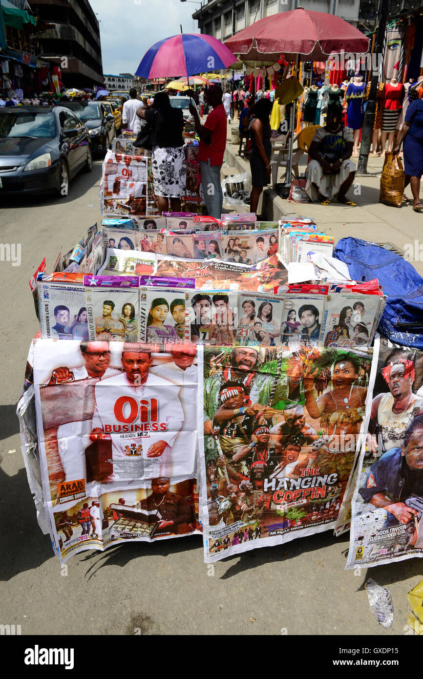 NIGERIA, City Lagos, roadside selling of motion picture by the Nigerian film industry called Nollywood on DVD, nigerian movie thriller Oil business and indian Bollywood movies Stock Photo