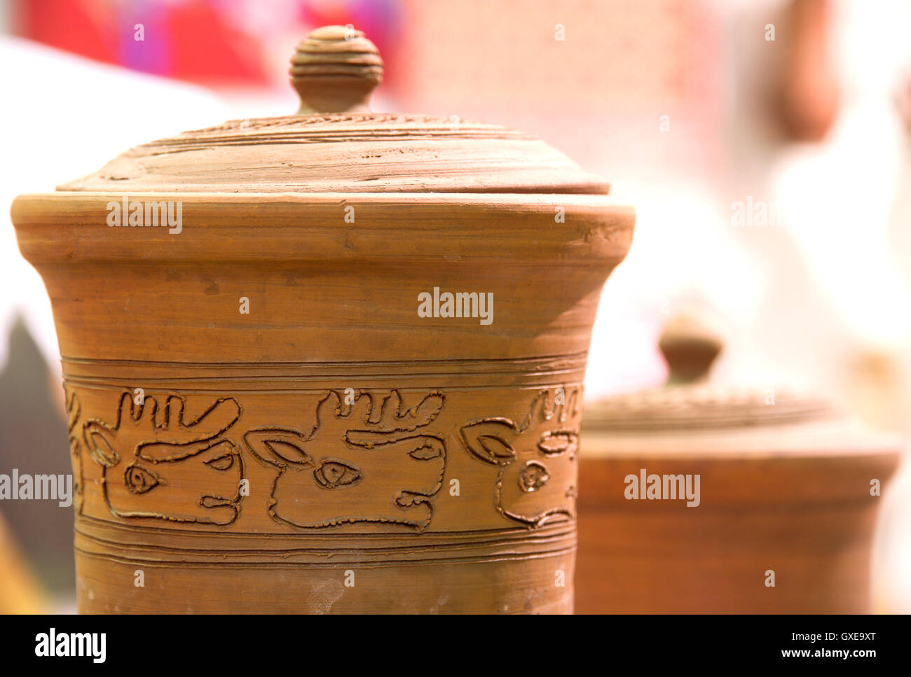 Handmade traditional decorated russian clay jug (fragment) on the shopboard at the flea market in Moscow (Russia). Stock Photo