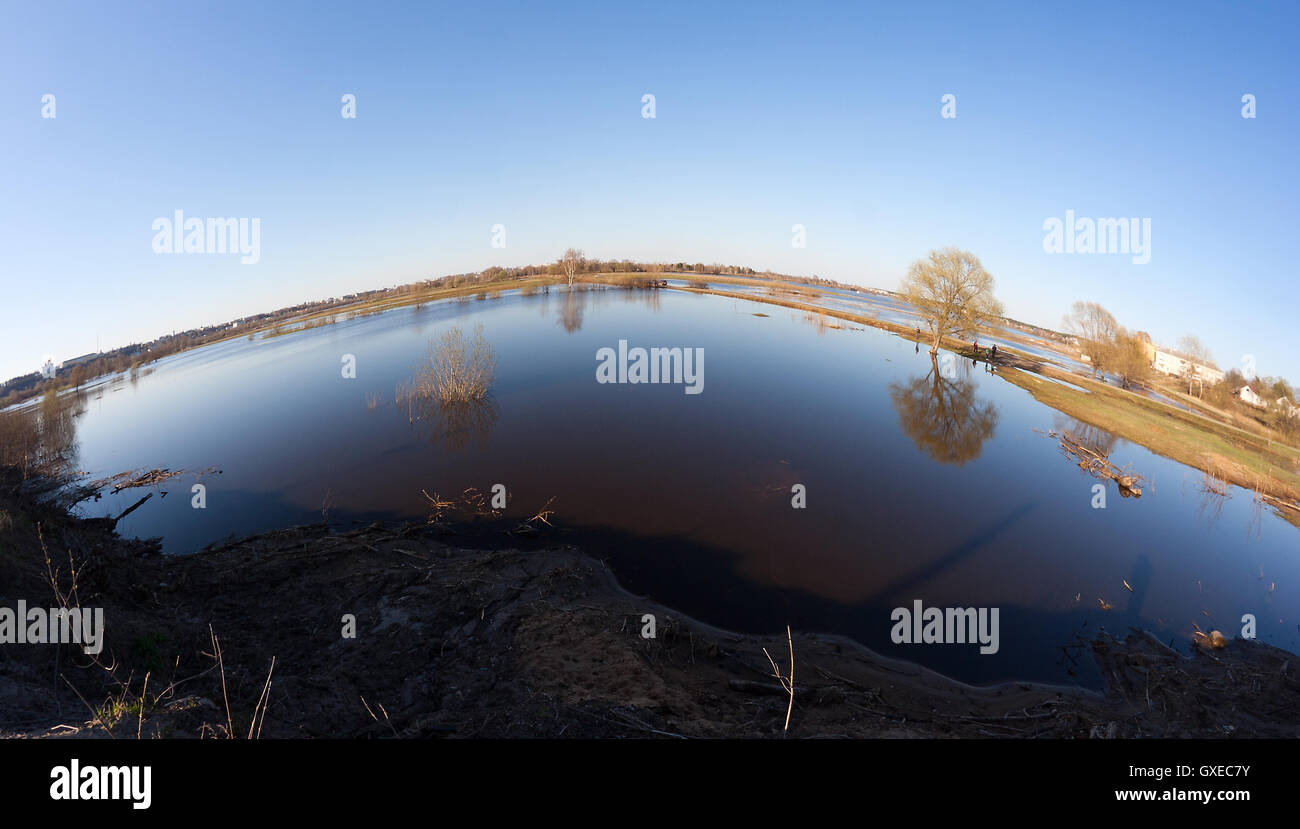 High water (flood, overflow) by a Spring time in the Klyazma river near Vladimir (Russia) with trees, lawns and roads underwater Stock Photo
