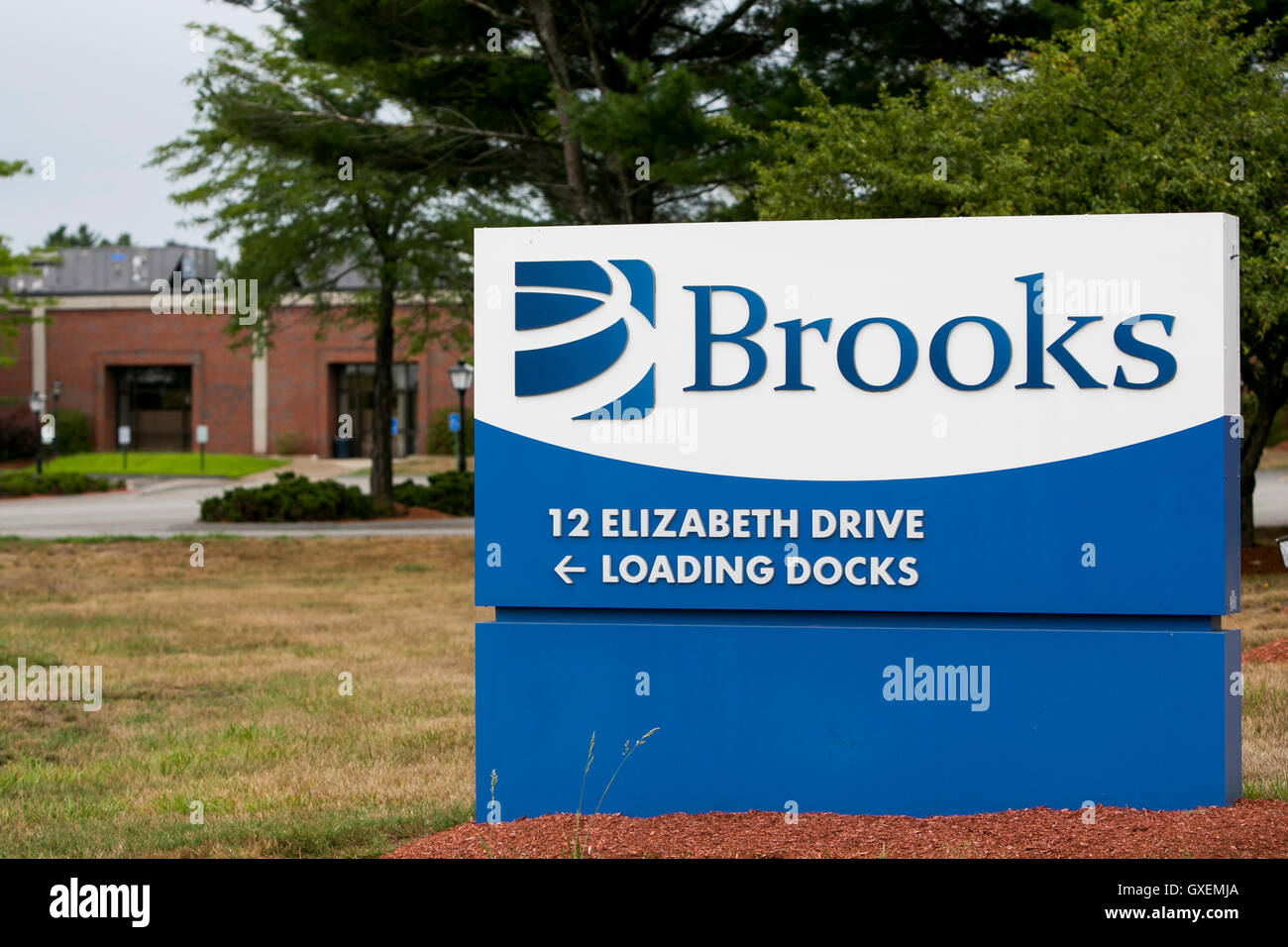 A logo sign outside of the headquarters of Brooks Automation in