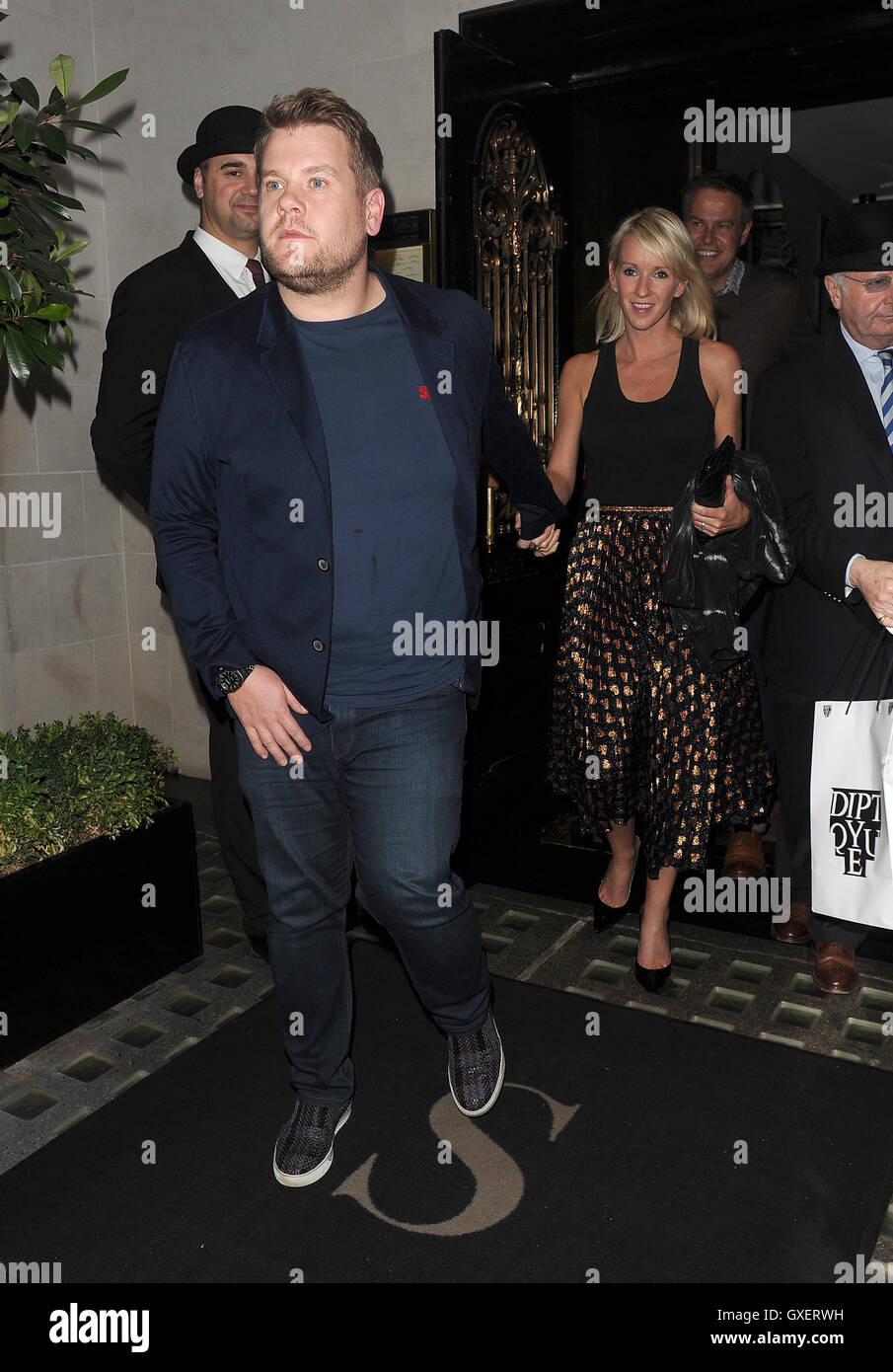 James Corden and his wife Julia Carey enjoy dinner with entrepreneur Peter Jones and his partner Tara Capp. The group were later joined by comedian David Walliams, who Corden greeted by grabbing his bum as he approached the table. After almost four hours Stock Photo