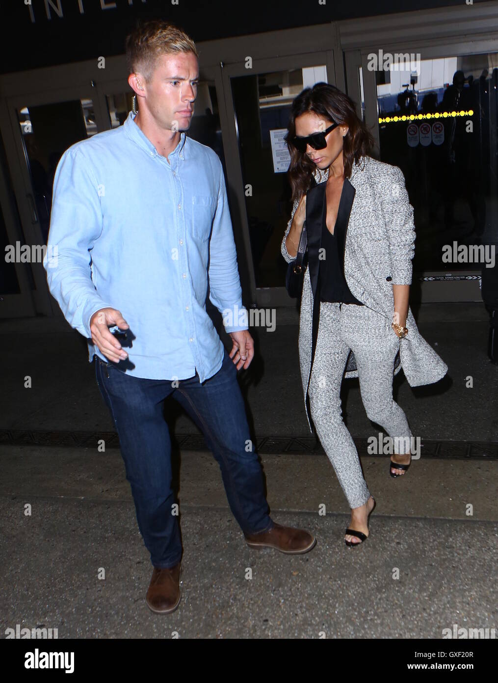 Victoria Beckham arrives at Los Angeles International (LAX) Airport surrounded by security  Featuring: Victoria Beckham Where: Los Angeles, California, United States When: 16 Jul 2016 Stock Photo