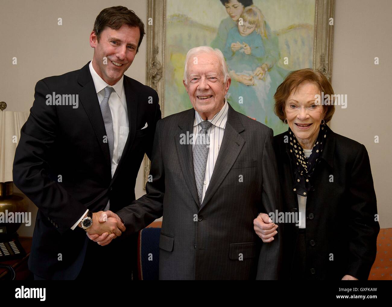Former U.S. President Jimmy Carter, shown with wife Rosalynn Carter (left) shakes hands with library director Mark Updegrove while accepting the LBJ Foundation award at The Carter Center January 13, 2016 in Atlanta, Georgia. The LBJ Liberty and Justice for All Award recognizes leadership in public service. Stock Photo