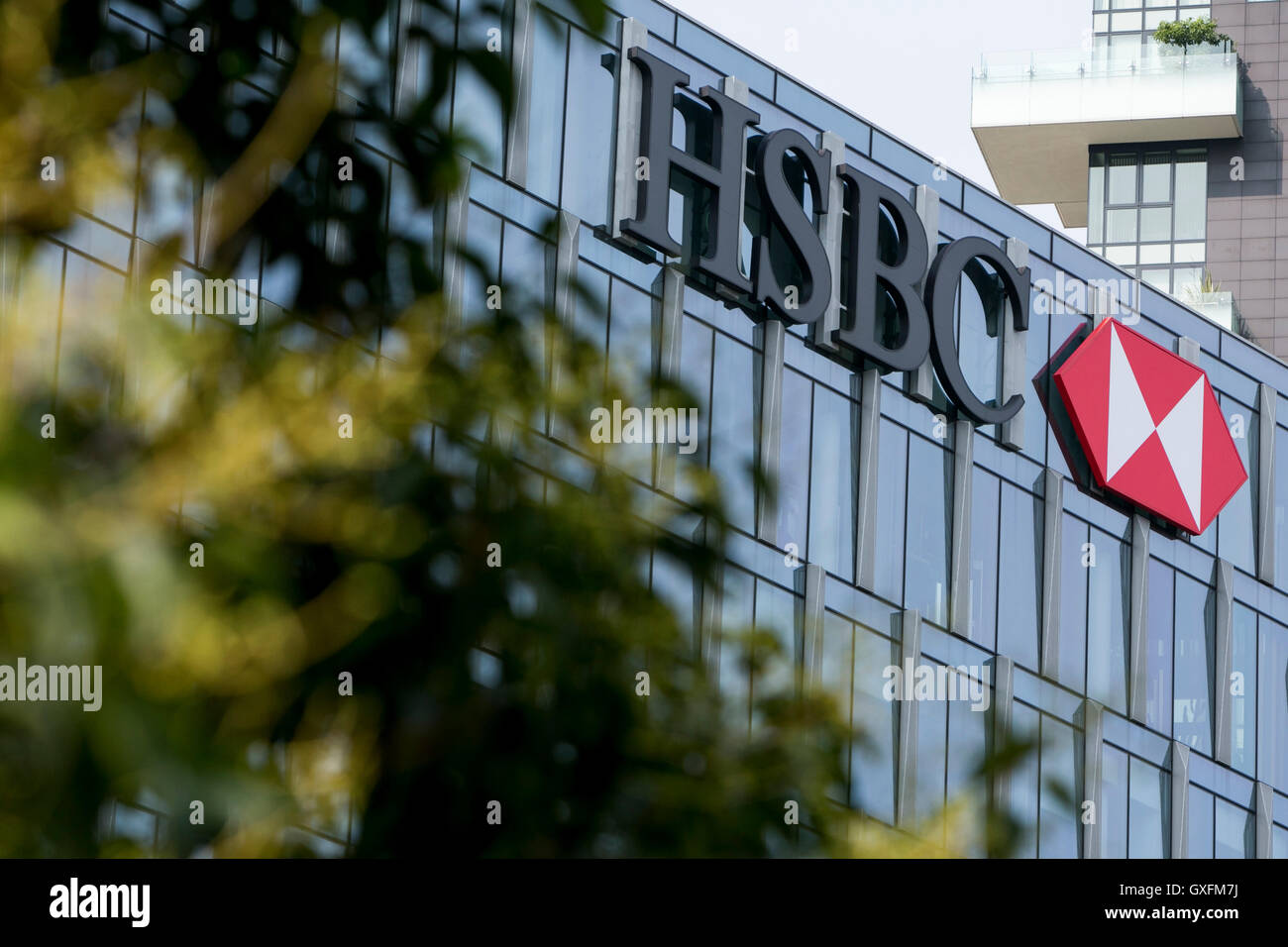 A logo sign outside of a facility occupied by HSBC Bank in Milan, Italy on September 3, 2016. Stock Photo