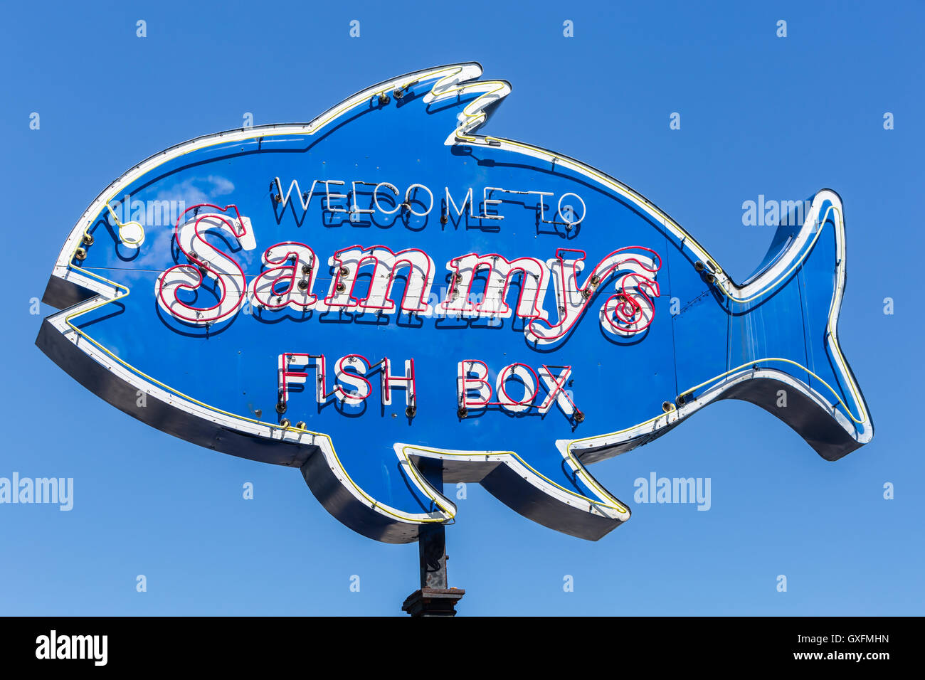 A fish-shaped neon sign welcomes diners to Sammy's Fish Box, a seafood restaurant on City Island in the Bronx, New York City. Stock Photo